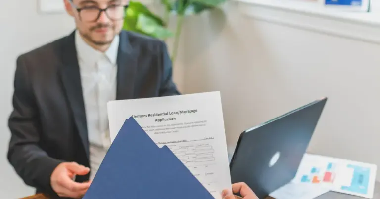 Consulente e cliente discutono una domanda di finanziamento con documenti sul tavolo
